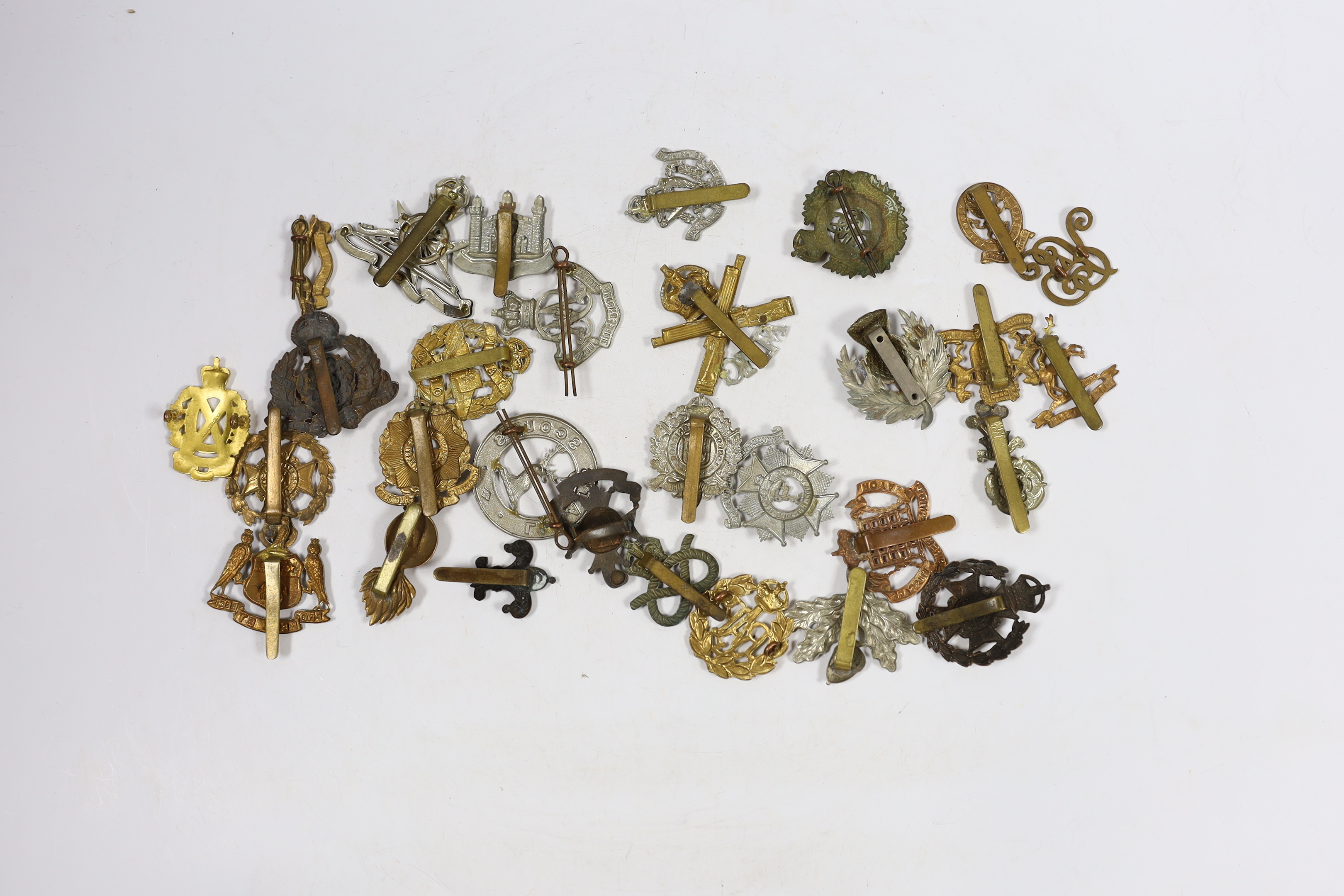 Thirty military cap badges including Royal Canadian Engineers, Royal Gloucestershire Hussars, the Robin Hoods, RAF, the Cambridgeshire Regiment, Tank Corps, Huntingdonshire, Westminster Dragoons, Cinque Ports, Derbyshire